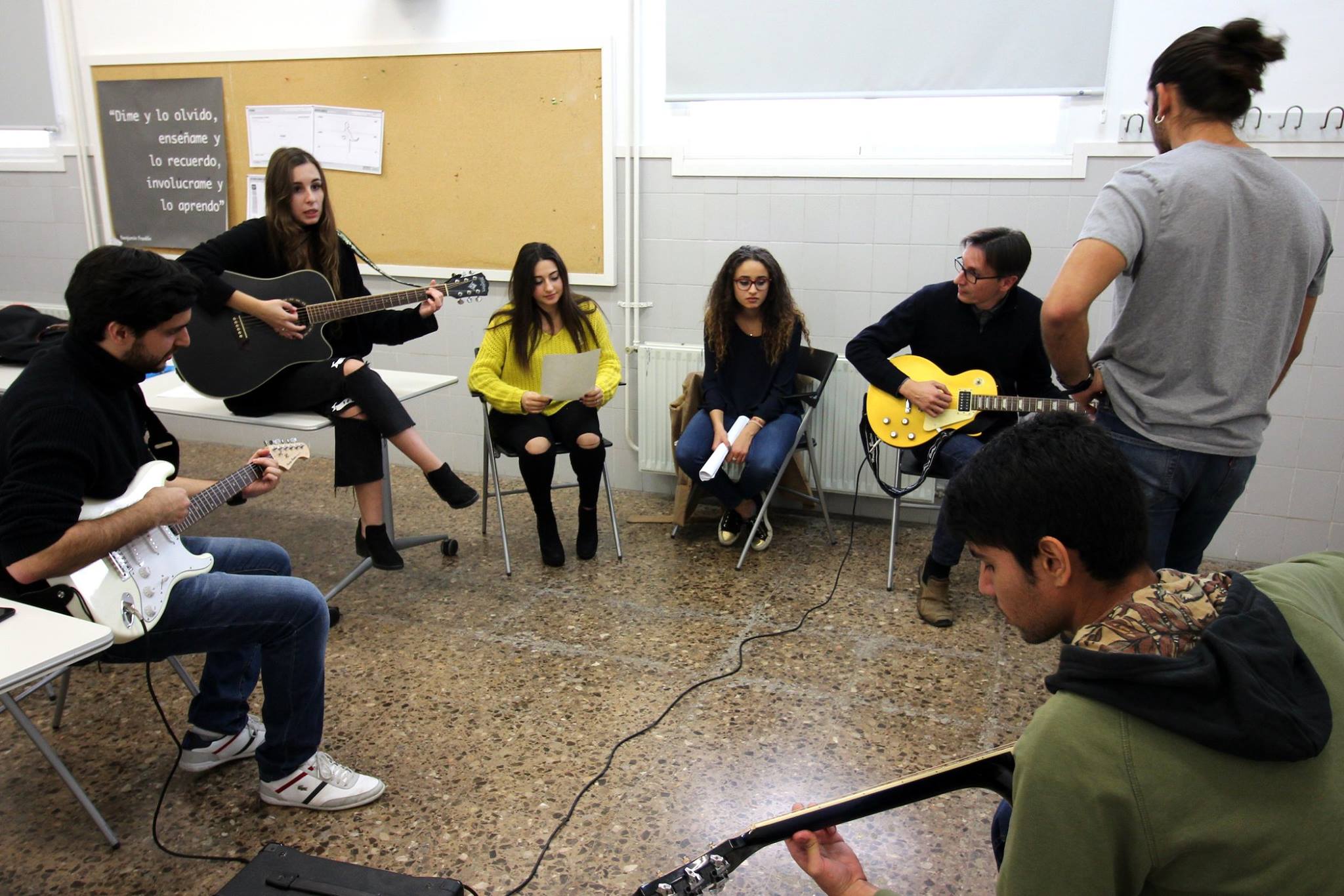ESET students and teachers learning to play the guitar.
