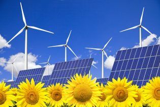 Wind turbines and solar panels on sunflowers field