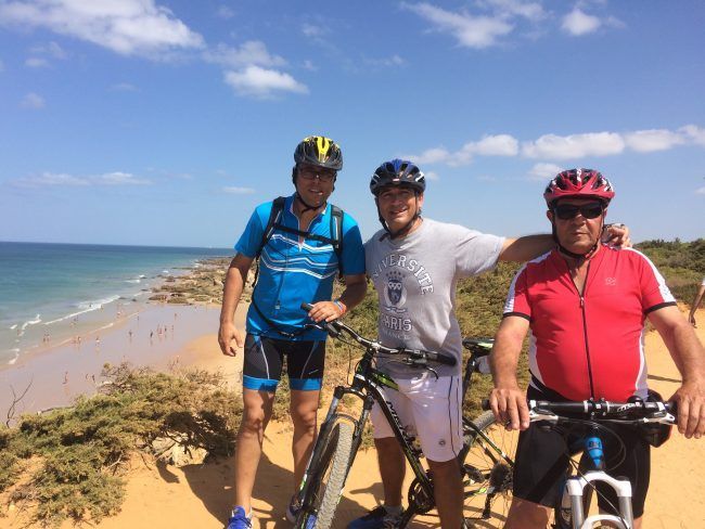 Tres amigos cicloturistas disfrutando del litoral gaditan